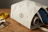 Interior lining of canvas tote bag with highlighted custom logo label placement and manufacturing detail