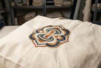 Embroidery branding fully displayed on canvas tote bag showing detailed thread craftsmanship