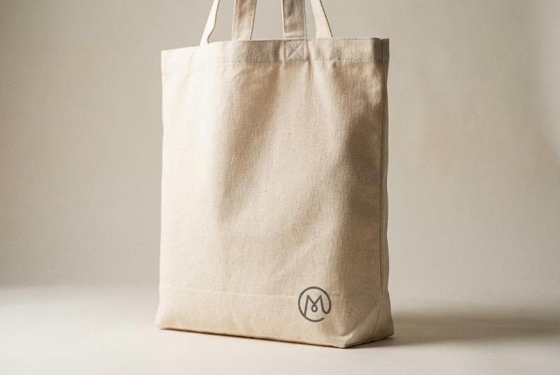 Canvas-tote-bag-featuring-corner-minimalist-logo-printing-for-subtle-fashion-branding.jpg